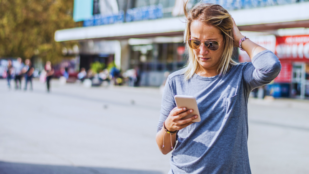 a woman looking at her phone trying to navigate Las Vegas